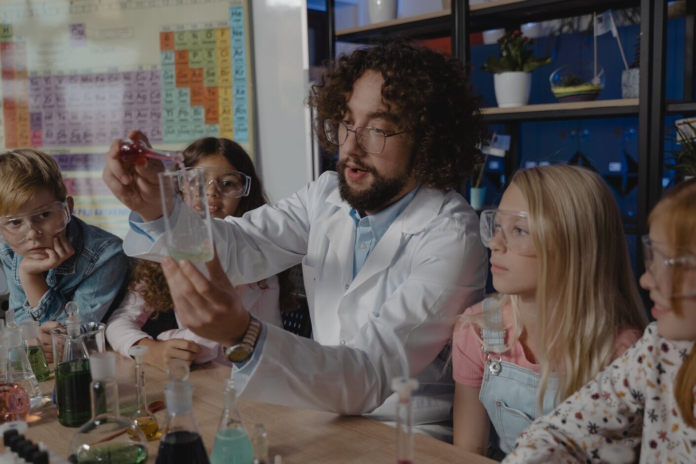 Image of professor and childs experimenting with chemicals